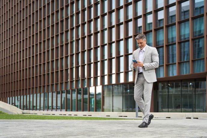 businessman wearing a grey suit walking out of a building in Oregon